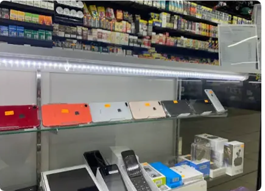 Mega Tobacco Vape & Wireless glass counter case holding boxed smartphones and tablets on the wireless side of the store