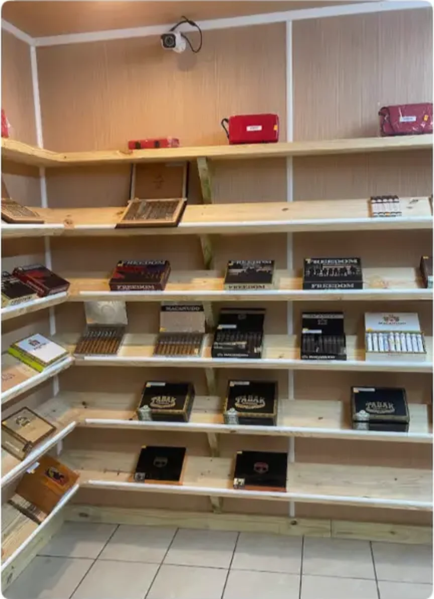 Mega Tobacco Vape & Wireless glass case of boxed vape devices, mods and starter kits under lit shelving