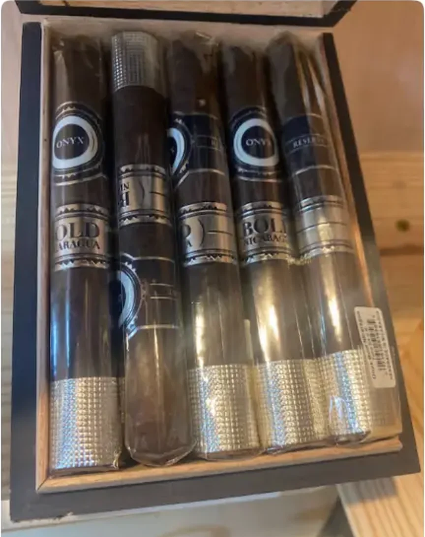 Close-up of premium cigars in an open wooden box on the shelf at Mega Tobacco Vape & Wireless