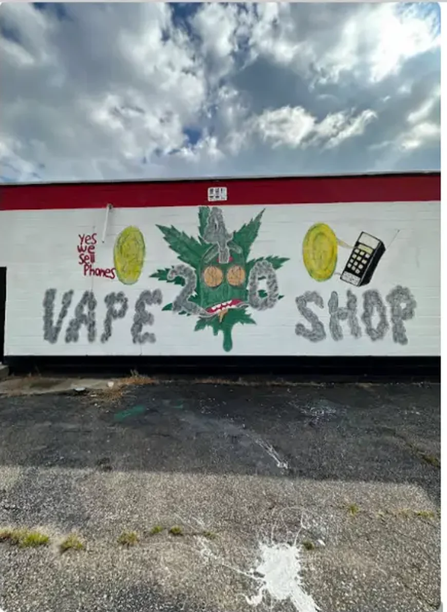 Hand-painted "Vape Shop — Yes We Sell Phones" mural on the exterior side wall of Mega Tobacco Vape & Wireless in Scotland Neck NC
