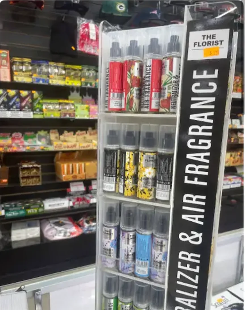 Mega Tobacco Vape & Wireless air freshener and odor neutralizer display stand in front of stocked shelving