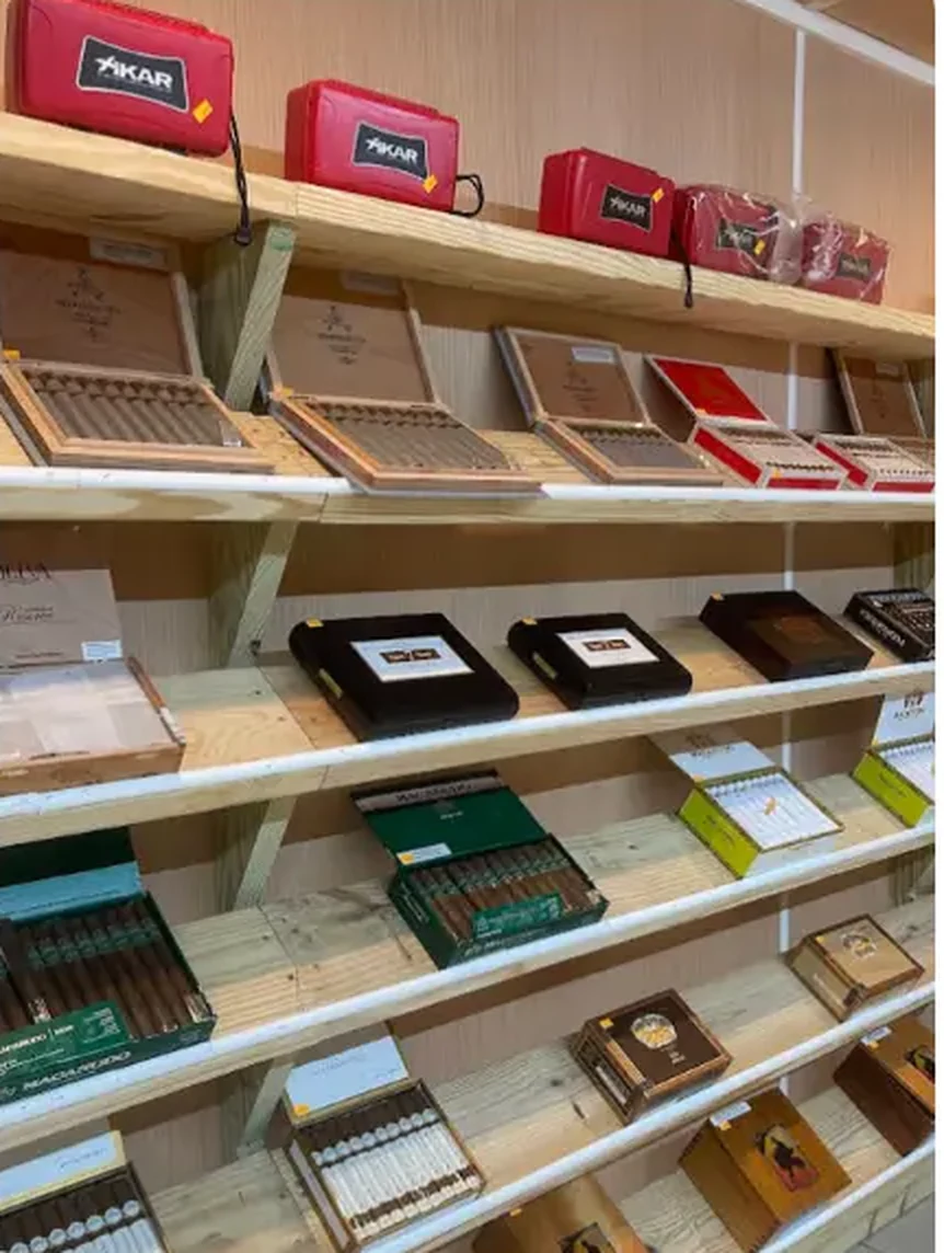 Mega Tobacco Vape & Wireless cigar room shelving with open cigar boxes, humidor cases and cigar accessories